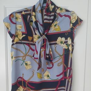 NY& Co multicolored blouse with short petal sleeves and neck bow. M.
